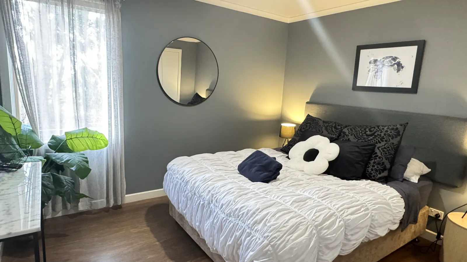 Bedroom with a white quilt, dark accent wall and bedside lighting — Two-bedroom Villa 107, Cowes, Phillip Island