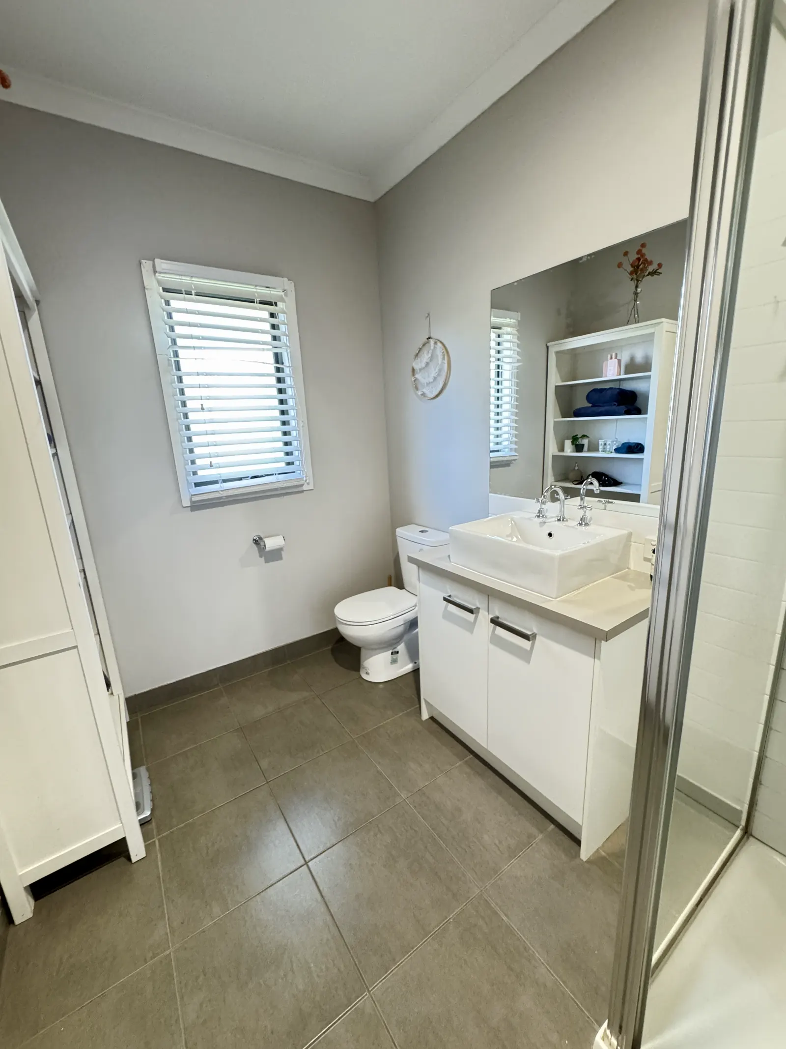 Bathroom with shower, toilet and a white vanity — Coastal Tones holiday home, Cowes, Phillip Island