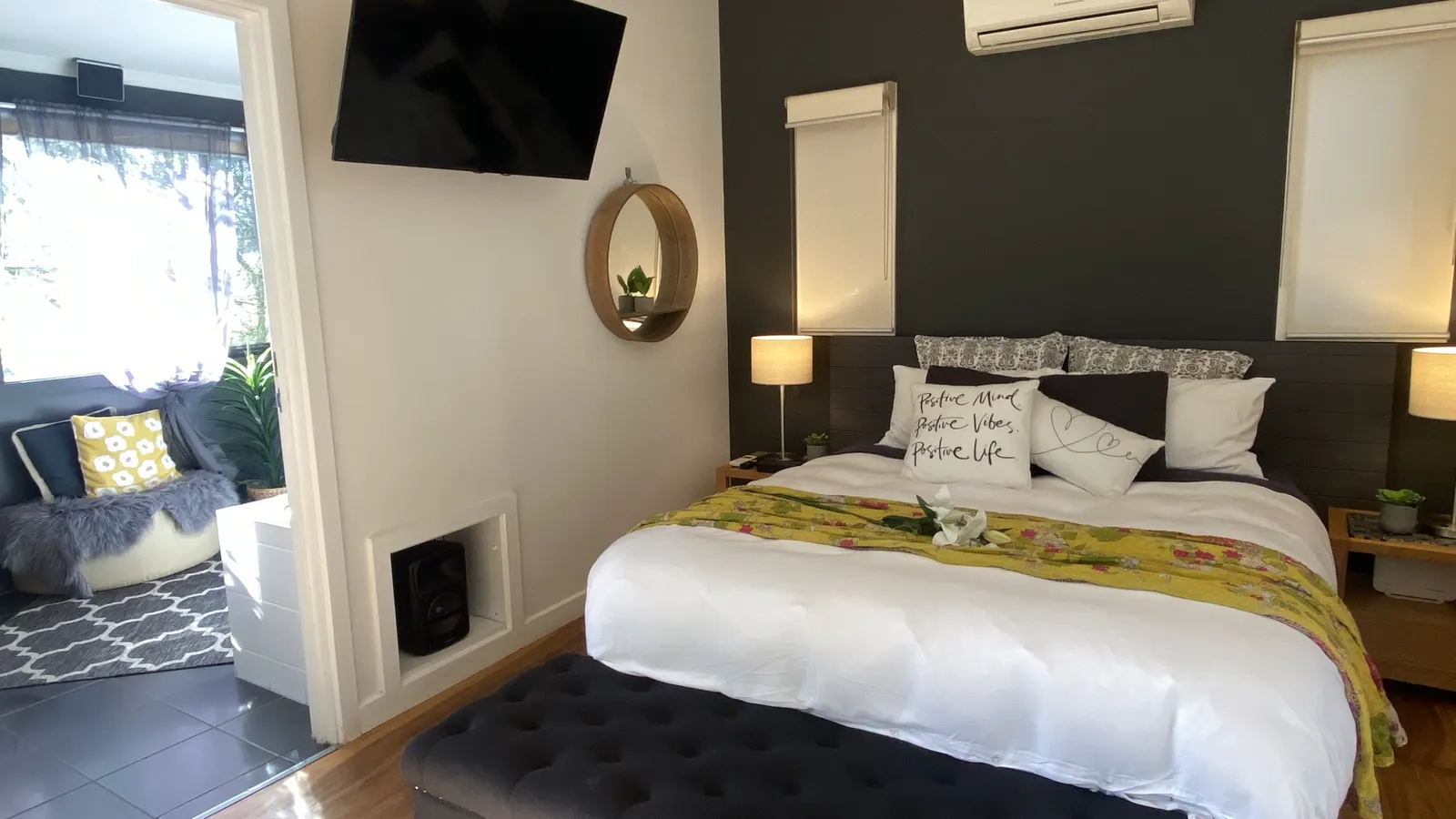 Studio bed beside the doorway to the separate private spa room — Couples Private Spa Retreat Villa 117, Cowes, Phillip Island