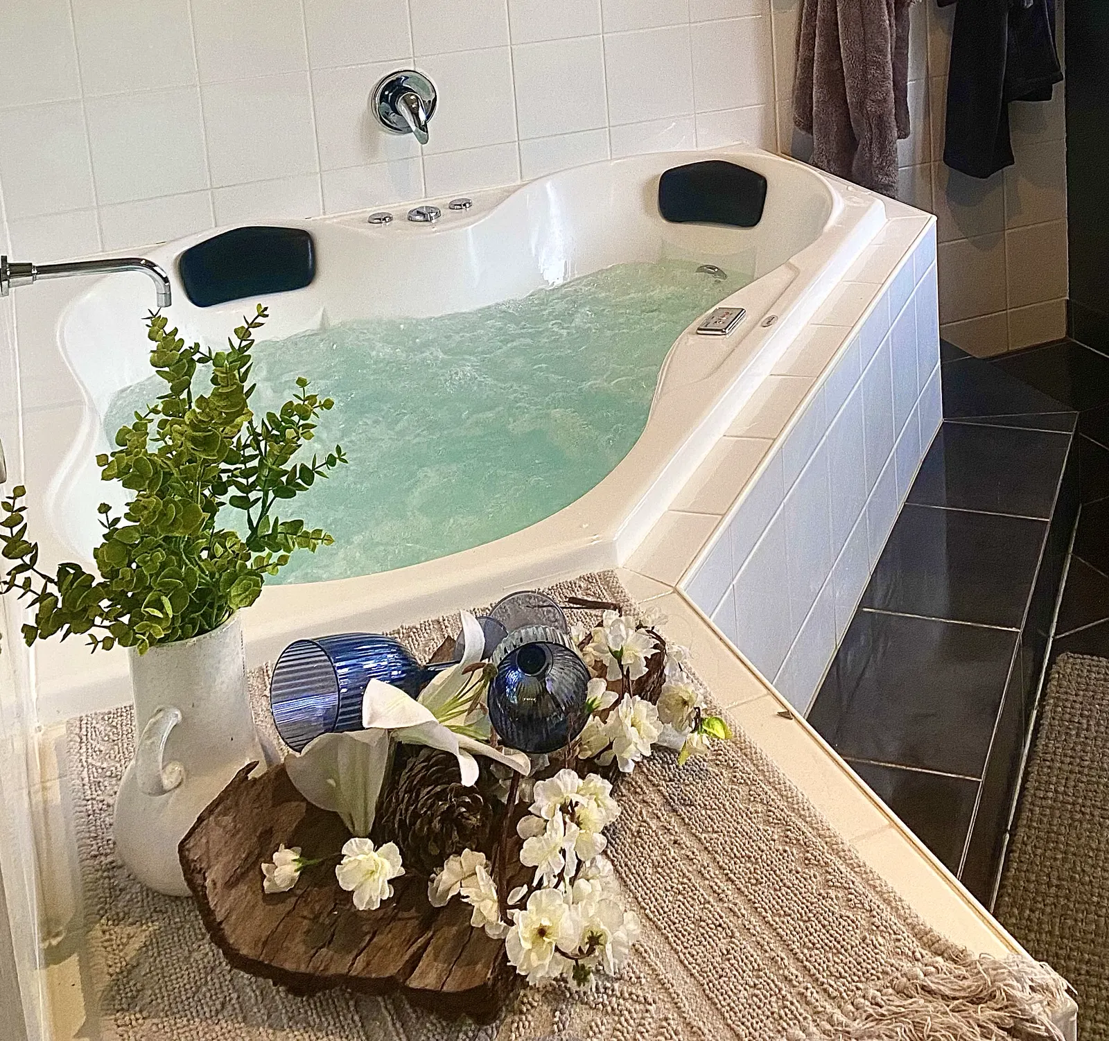 Filled private spa bath with greenery and flowers beside the water — Couples Private Spa Retreat Villa 117, Cowes, Phillip Island